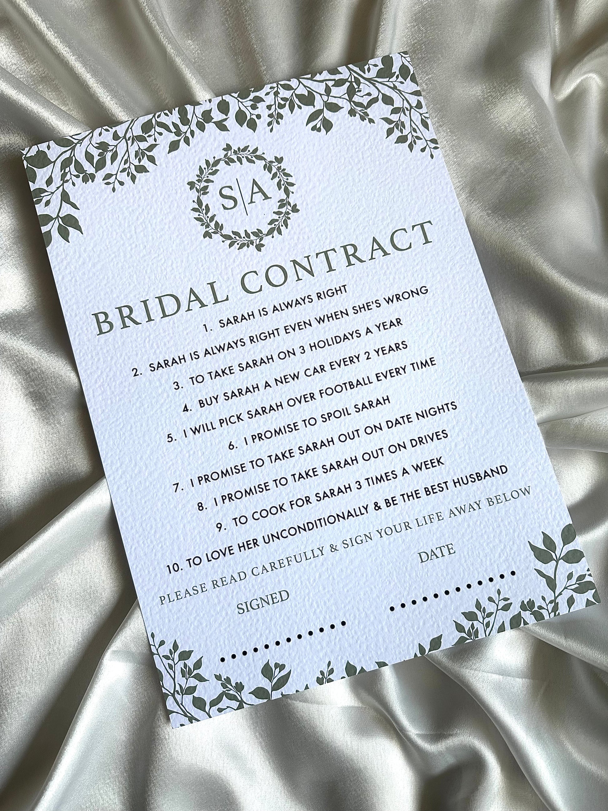 Bridal contract card with decorative elements on a satin background