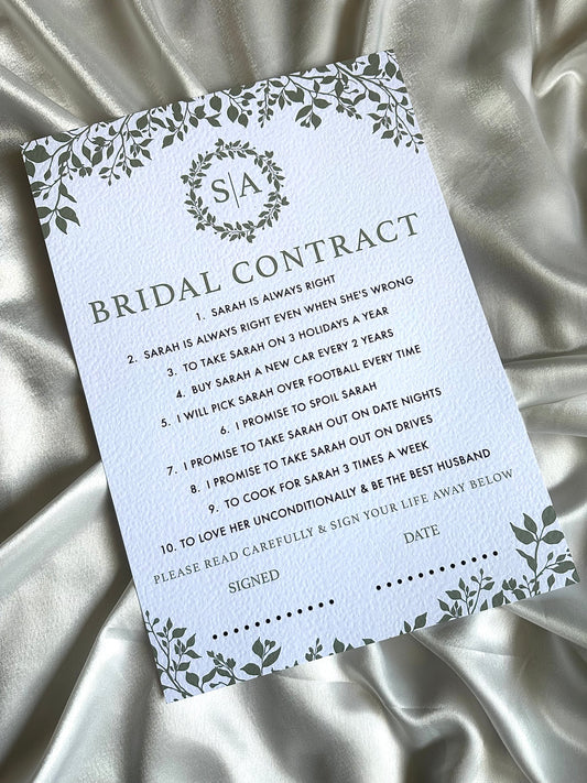 Bridal contract card with decorative elements on a satin background